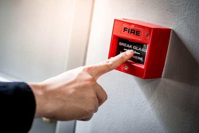 man touching fire alarm-1