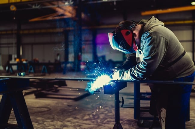 man in manufacturing plant welding