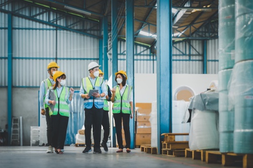 Staff in furniture warehouse with clipboard