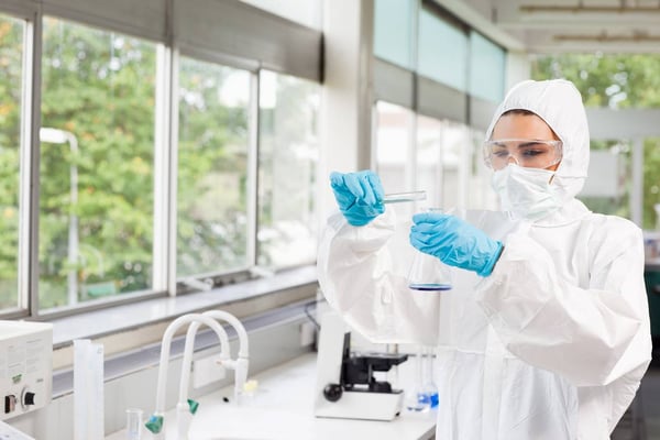 Lab worker using chemical in test tube