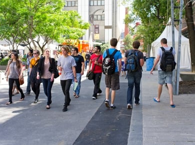 students talking while walking on the university campus