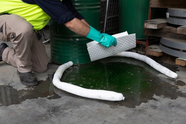 Spill kit being used by worker 700
