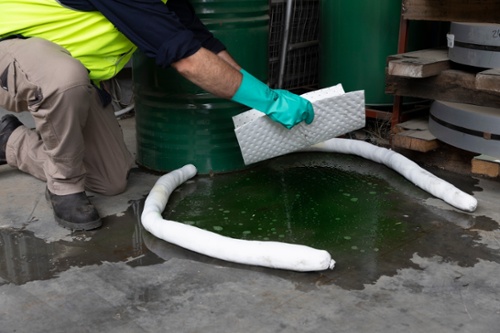 Spill kit being used by worker