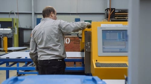 Worker controlling the manufacturing machine