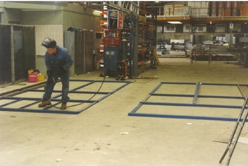 worker welding the cabinet frame at the factory