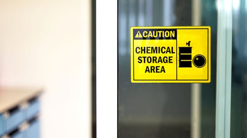 lab door with sign indicating chemical storage area