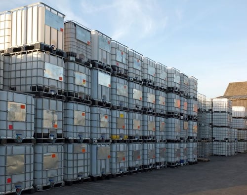 Rows of stackable IBCs in the outdoor yard of the factory