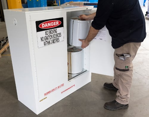 staff member using a toxic substance storage cabinet