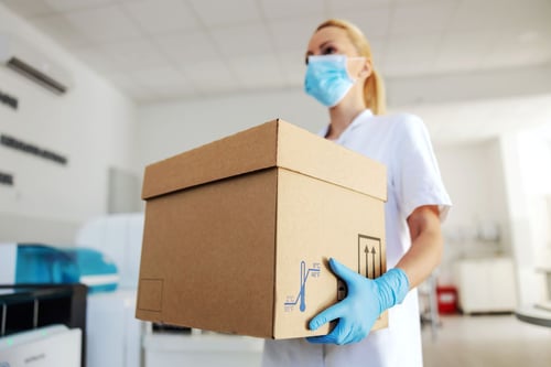 lab worker holding a chemical package