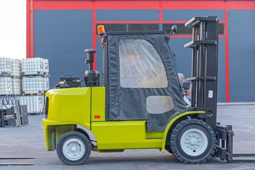 yellow forklift and IBCs in front of the warehouse