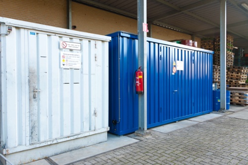 two different dangerous goods containers under an outdoor awning
