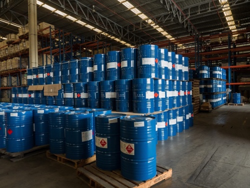 flammable liquid drums on wooden crates in warehouse