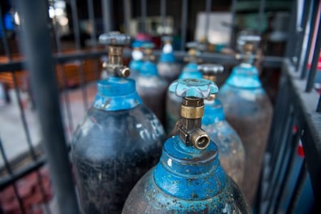 gas bottles in a storage cage in the workplace