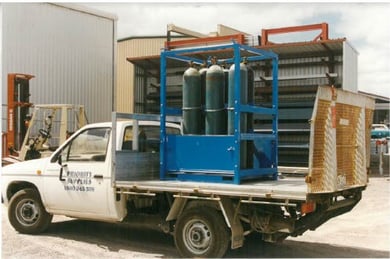 a white truck with gas cylinders in cage