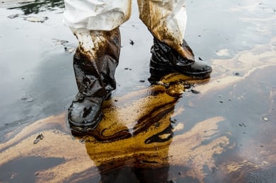 worker in protective boots standing in a chemical spill